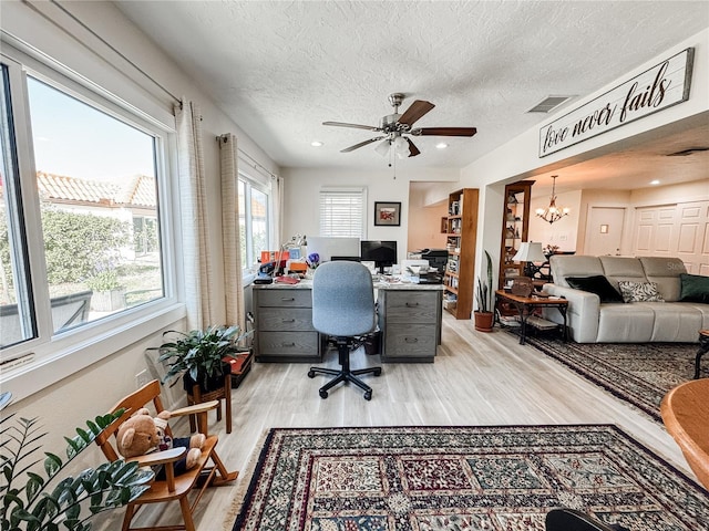 office space with a textured ceiling, recessed lighting, a notable chandelier, visible vents, and light wood-type flooring