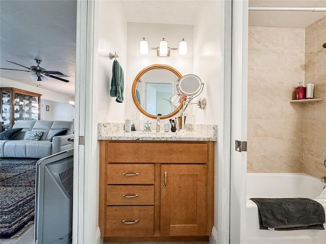 bathroom featuring shower / bath combination, ensuite bath, vanity, and a ceiling fan