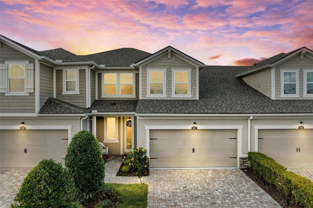 11607 Meadowgate Pl, Bradenton, FL 34211 - view of property with decorative driveway, a garage, and roof with shingles