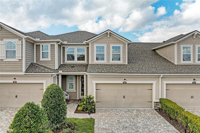 11607 Meadowgate Pl, Bradenton, FL 34211 - multi unit property with decorative driveway, an attached garage, and a shingled roof