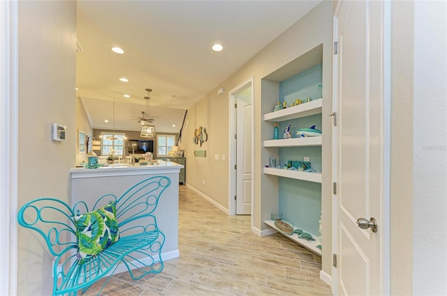 11607 Meadowgate Pl, Bradenton, FL 34211 - hall featuring recessed lighting, light wood-style flooring, built in shelves, and baseboards