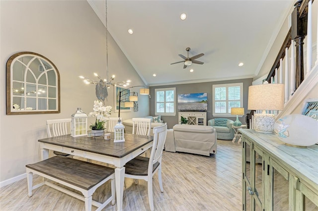 11607 Meadowgate Pl, Bradenton, FL 34211 - dining room with light wood-type flooring, lofted ceiling, ornamental molding, and ceiling fan with notable chandelier