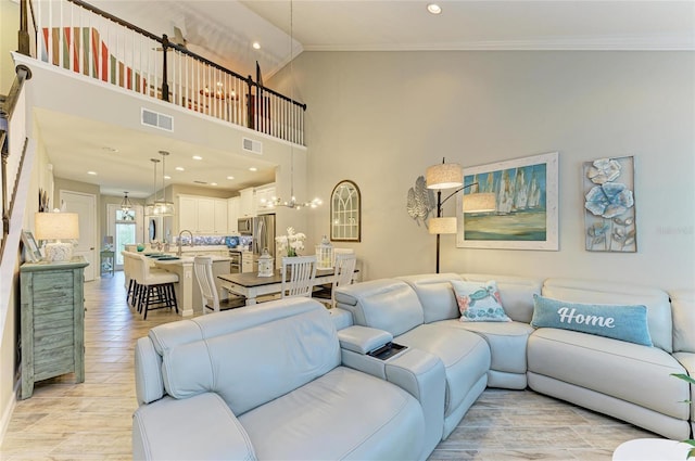11607 Meadowgate Pl, Bradenton, FL 34211 - living room with visible vents, a towering ceiling, and ornamental molding