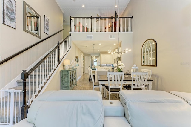 11607 Meadowgate Pl, Bradenton, FL 34211 - living area featuring stairway, recessed lighting, a high ceiling, and visible vents