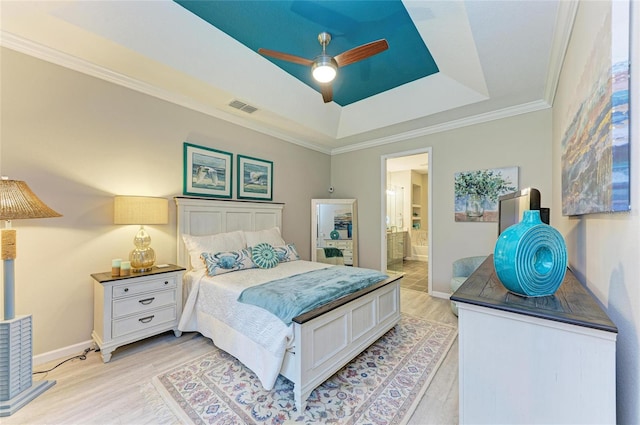 11607 Meadowgate Pl, Bradenton, FL 34211 - bedroom featuring visible vents, a raised ceiling, light wood-style floors, and baseboards