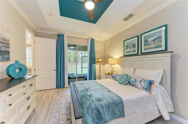 11607 Meadowgate Pl, Bradenton, FL 34211 - bedroom featuring a tray ceiling, visible vents, light wood-style flooring, and crown molding