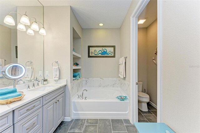 11607 Meadowgate Pl, Bradenton, FL 34211 - bathroom featuring baseboards, toilet, a bath, and vanity
