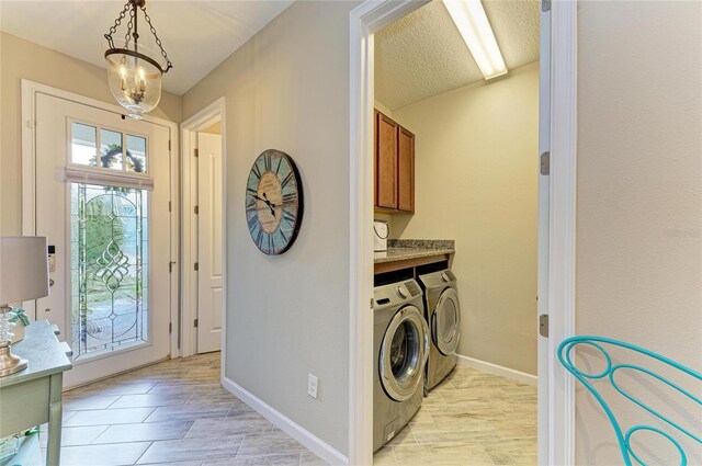 11607 Meadowgate Pl, Bradenton, FL 34211 - laundry area with baseboards, cabinet space, a textured ceiling, and washing machine and clothes dryer