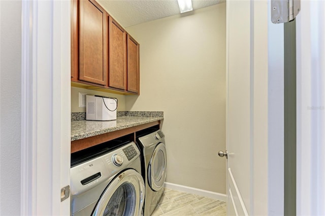 11607 Meadowgate Pl, Bradenton, FL 34211 - laundry area with washer and clothes dryer, cabinet space, a textured ceiling, and baseboards
