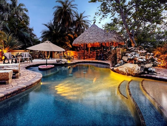 pool with a gazebo and a patio area