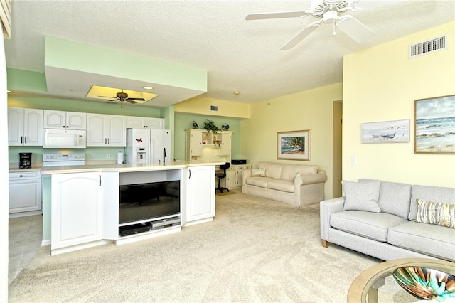 living room featuring light carpet, a textured ceiling, visible vents, and a ceiling fan