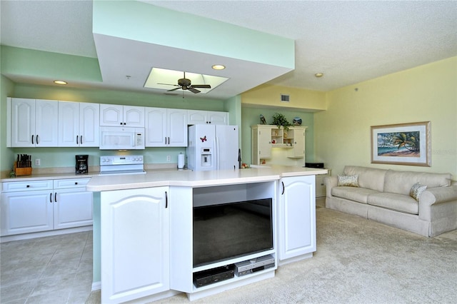 kitchen with ceiling fan, white appliances, open floor plan, and white cabinetry