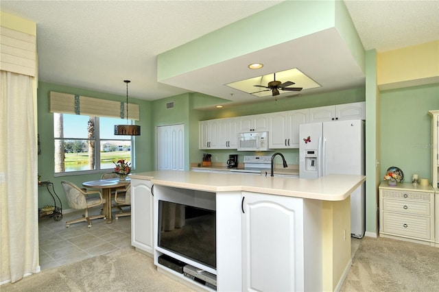 kitchen with light colored carpet, white appliances, visible vents, white cabinetry, and light countertops