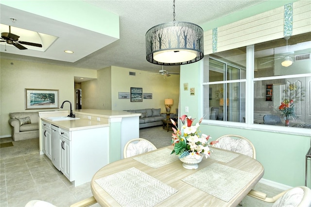 dining room with ceiling fan, visible vents, and a textured ceiling