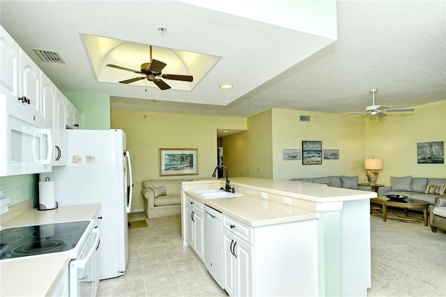 kitchen featuring white appliances, visible vents, a sink, and open floor plan