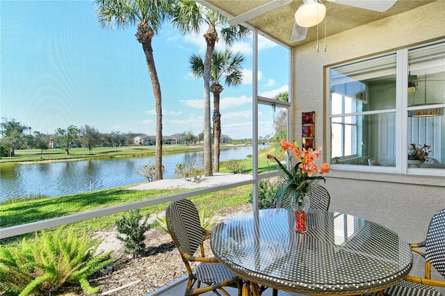 sunroom / solarium featuring a water view