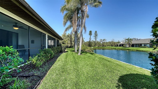 view of yard with a ceiling fan and a water view