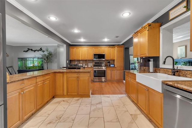 kitchen with marble finish floor, stainless steel appliances, crown molding, a sink, and recessed lighting