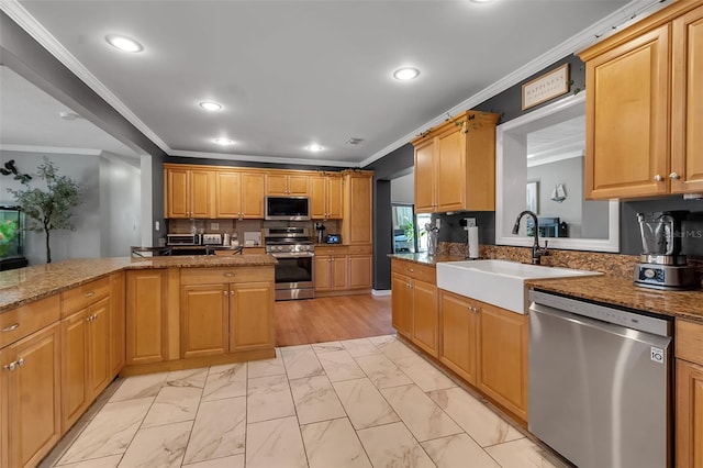 kitchen featuring appliances with stainless steel finishes, marble finish floor, crown molding, and a sink