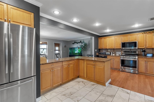 kitchen featuring marble finish floor, stainless steel appliances, ornamental molding, and stone countertops