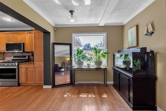 kitchen with light wood-type flooring, brown cabinetry, stainless steel appliances, and a textured ceiling