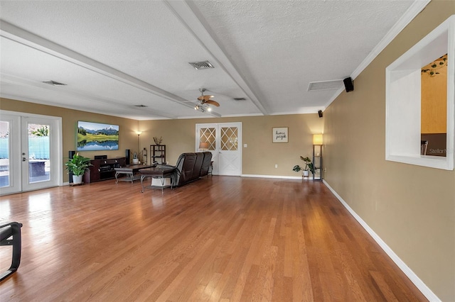 unfurnished room featuring ceiling fan, light wood finished floors, visible vents, and baseboards