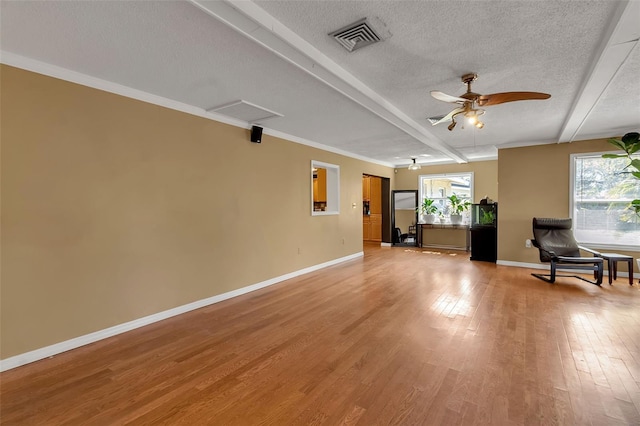 unfurnished room with baseboards, visible vents, a ceiling fan, a textured ceiling, and light wood-type flooring