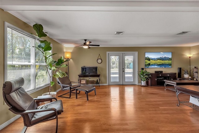 sitting room with a wealth of natural light, french doors, visible vents, and light wood finished floors