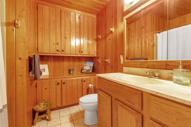 full bathroom with wooden walls, toilet, a shower with curtain, tile patterned flooring, and vanity