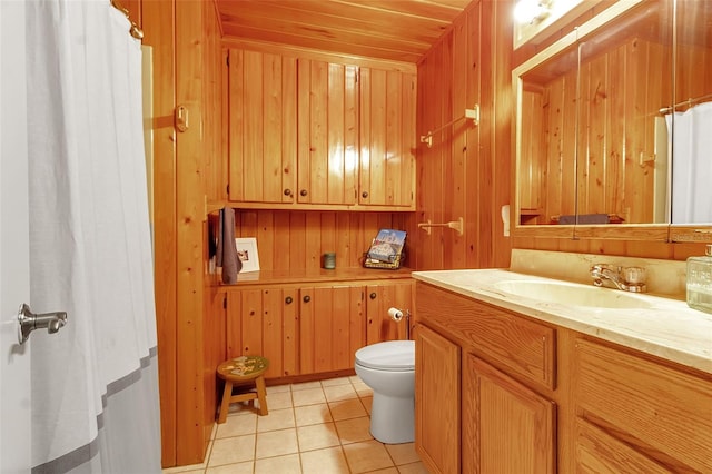 full bath featuring wooden walls, toilet, wooden ceiling, tile patterned flooring, and vanity