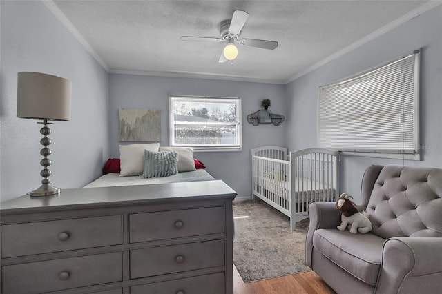 bedroom with crown molding, a textured ceiling, and ceiling fan