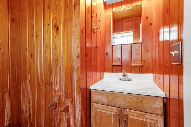 bathroom featuring wood walls and vanity