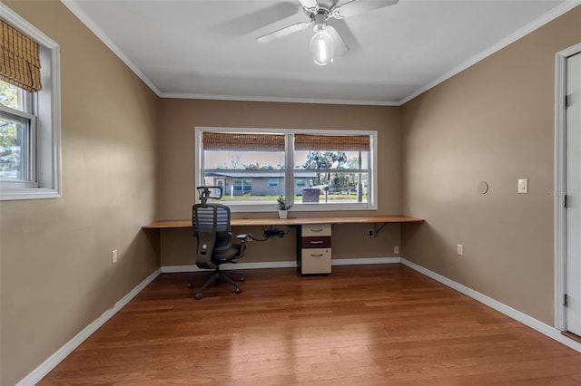 home office with a healthy amount of sunlight, built in study area, and wood finished floors