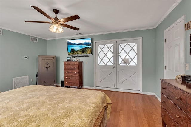 bedroom with ornamental molding, light wood-type flooring, and visible vents