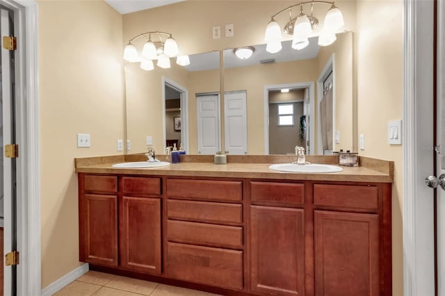 bathroom with double vanity, tile patterned flooring, and a sink