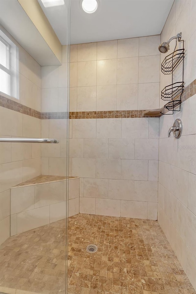 full bathroom with tiled shower