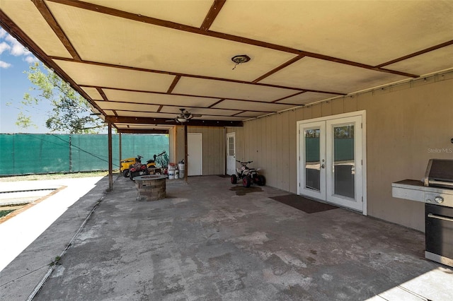 view of patio / terrace featuring a fire pit, french doors, and fence