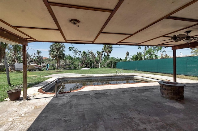 view of patio / terrace with an outdoor pool and fence