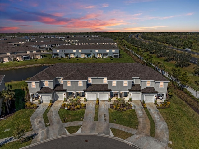 birds eye view of property with a water view and a residential view