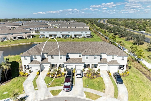 bird's eye view featuring a water view and a residential view