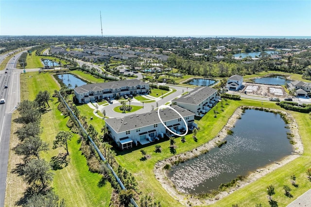 birds eye view of property with a water view