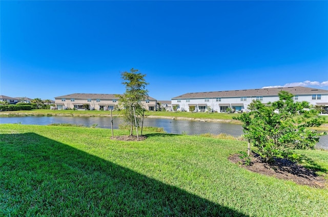 view of yard featuring a water view and a residential view