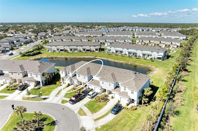 drone / aerial view with a residential view and a water view