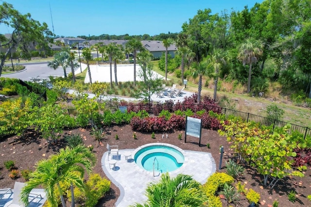 view of swimming pool with a community hot tub and fence