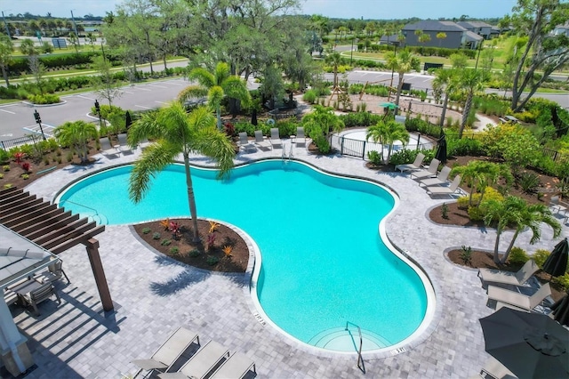 pool featuring a patio area and fence