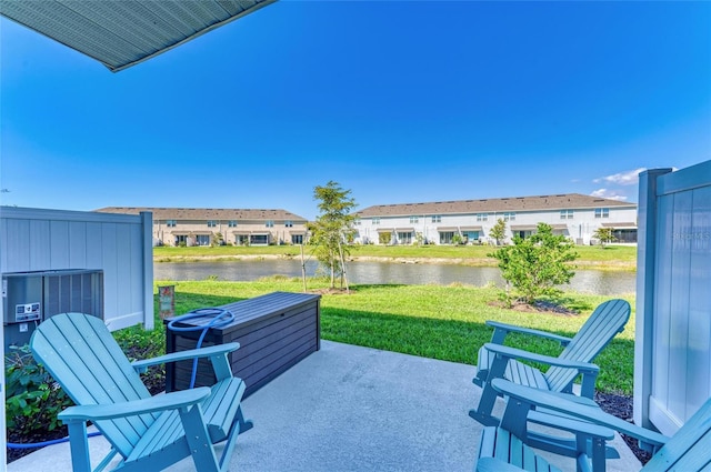 view of patio with a residential view and a water view