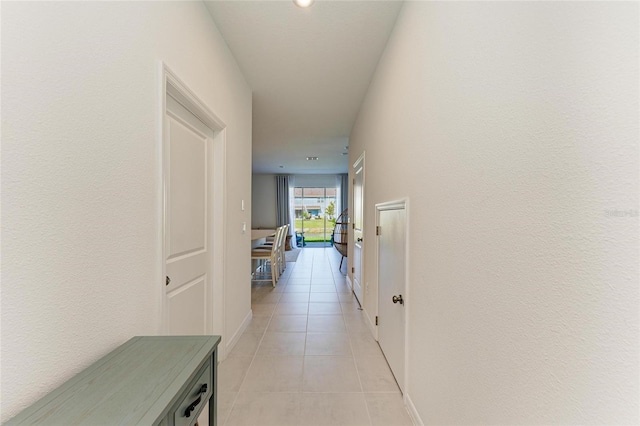 hall with light tile patterned floors