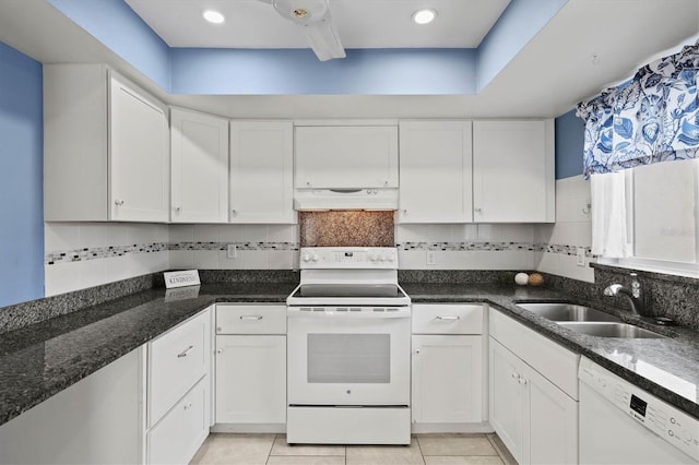 kitchen featuring white appliances, custom range hood, a sink, and white cabinetry