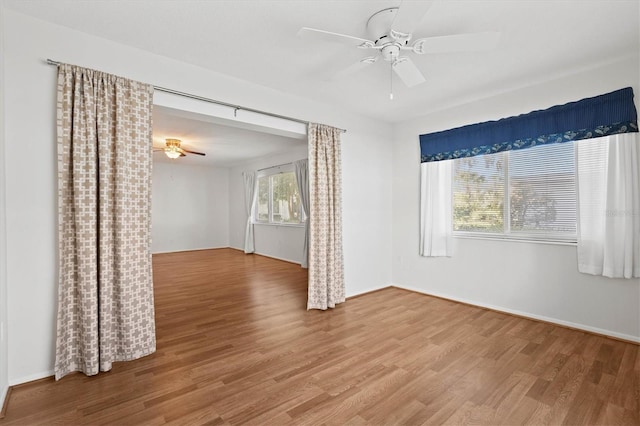 empty room featuring ceiling fan and wood finished floors