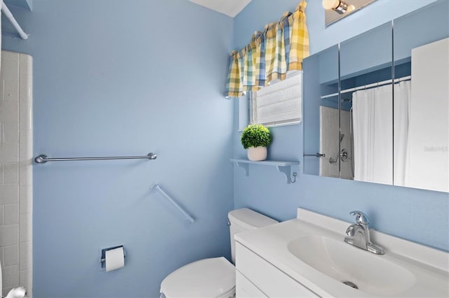 bathroom featuring toilet, vanity, and a shower with shower curtain